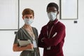 Two Workers Wearing Masks in Art Gallery Royalty Free Stock Photo