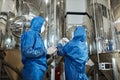 Two workers wearing protective suits at chemical factory Royalty Free Stock Photo