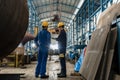 Two workers wearing yellow hard hat and blue uniform