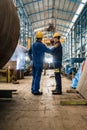 Two workers wearing yellow hard hat and blue uniform Royalty Free Stock Photo