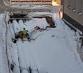 Two workers welding on a big pipe among the snow in a urban construction site, Helsinki Finland Royalty Free Stock Photo