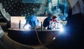 Two workers welding in a factory manufacturing boilers Royalty Free Stock Photo