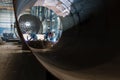 Two workers welding in a factory manufacturing boilers