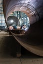 Two workers welding in a factory manufacturing boilers