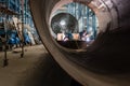 Two workers welding in a factory manufacturing boilers