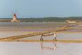 Two workers at the west coast salt pans in Marsala