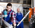 Two workers working on machine