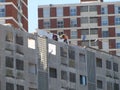 Two workers working on the roof of a new building in a constrcution site Royalty Free Stock Photo