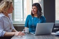 Two working as one. two businesswomen using a laptop together in an office. Royalty Free Stock Photo