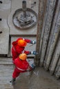 A working driller installs a drill pipe raised from a well. Royalty Free Stock Photo