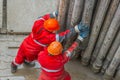 A working driller installs a drill pipe raised from a well. Royalty Free Stock Photo