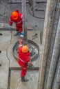 A working driller installs a drill pipe raised from a well. Royalty Free Stock Photo