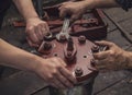 The two working hands are tightening the big nut with a wrench Royalty Free Stock Photo