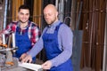 Two workmen in PVC shop Royalty Free Stock Photo