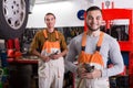 Two workmen toiling in workshop Royalty Free Stock Photo