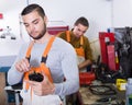 Two workmen toiling in workshop Royalty Free Stock Photo