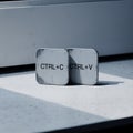Two worn computer keyboard keys labeled Ctrl C and Ctrl V Royalty Free Stock Photo