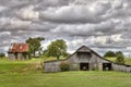 Dual Wooden Barns Under a Cloudy Sky