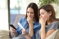 Worried women checking smart phones content