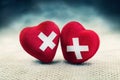 Two wounded hearts with a medical first aid patch united by common problems. Heart broken, Love and Valentines day concept