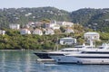 Two Yachts Below Tropical Homes Royalty Free Stock Photo