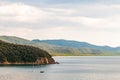 Two yahts floating near the scenic landscape of Cala Violina beach in Tyrrhenian Sea bay surrounded by green forest in province of Royalty Free Stock Photo