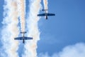 Two Yakovlev Yak-52/50 aircraft making smoke