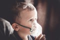 Two year old boy making inhalation with nebulizer at home Royalty Free Stock Photo