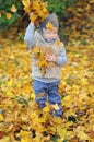 Portrait of a boy throwing autumn leaves in the air Royalty Free Stock Photo