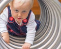 Cute little girl crawling through the tunnel