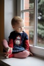 Two years old toddler girl by the window Royalty Free Stock Photo