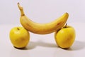 Two yellow apples and a banana on a white background Royalty Free Stock Photo