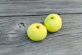Two yellow apples on board Royalty Free Stock Photo