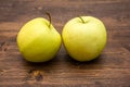 Two yellow apples on wood Royalty Free Stock Photo