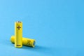 Two yellow batteries on a blue background with place for text Royalty Free Stock Photo