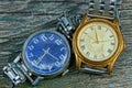 Two yellow and blue old shabby watch with a metal strap Royalty Free Stock Photo