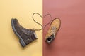 Two yellow and brown men`s and women`s winter suede leather stylish boots on color background. Laces in heart shape. Casual tren Royalty Free Stock Photo