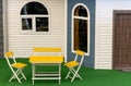 Two yellow chairs in front of a house exterior Royalty Free Stock Photo