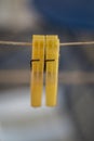 Two yellow Clothes Pins hunging on rope together Royalty Free Stock Photo