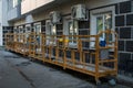 Two yellow construction overhead mobile elevators stand on the ground next to a building under renovation Royalty Free Stock Photo