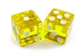 Two yellow glass dice, macro photography. Isolated on white with light shadow. The result is one and five. Royalty Free Stock Photo