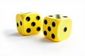 Two Yellow Dice Showing Different Numbers on a White Background for Games and Fun Royalty Free Stock Photo