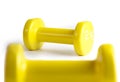 Two yellow  dumbbells isolated on white background with clipping path Royalty Free Stock Photo