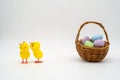 Two yellow easter chicks chatting by easter basket full of speck Royalty Free Stock Photo