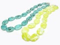 Two yellow and green colored beads Royalty Free Stock Photo