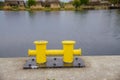 Two yellow mooring post at the harbor or marina port Royalty Free Stock Photo
