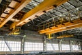 Two yellow overhead cranes in engineering plant shop Royalty Free Stock Photo