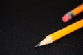 Two yellow Pencils on dark black blurred background. stationery. Office tool. Business concept. Royalty Free Stock Photo