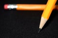Two yellow Pencils on dark black blurred background. stationery. Office tool. Business concept. Royalty Free Stock Photo