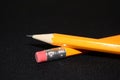 Two yellow Pencils on dark black blurred background. stationery. Office tool. Business concept. Royalty Free Stock Photo